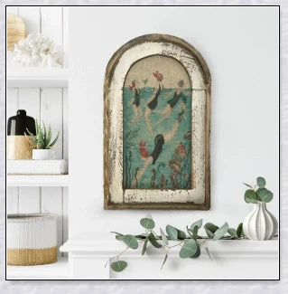 Decorative wall art featuring multiple swimmers and mermaids in a serene, aquatic-themed design
