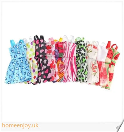 A diverse collection of 85 Barbie doll accessories including colourful dresses, shoes, bags, and jewellery.