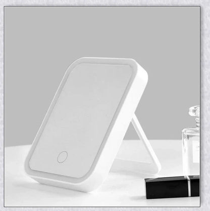 Traby Hand Smart Makeup Mirror with touch screen controls, adjustable brightness, and 45-degree rotation for easy on-the-go beauty touch-ups