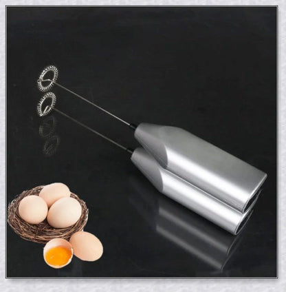 A compact, stainless steel milk frother with a modern, minimalist design, perfect for creating rich, velvety milk foam for coffee and tea drinks.
