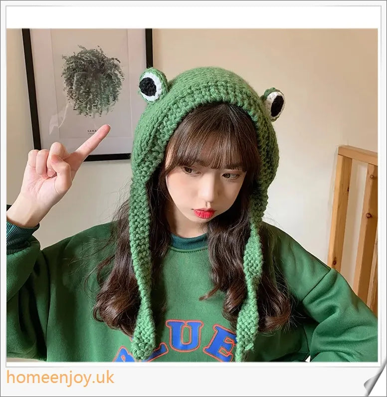 A cosy and stylish woollen hat featuring a charming cartoon frog design with big, expressive eyes