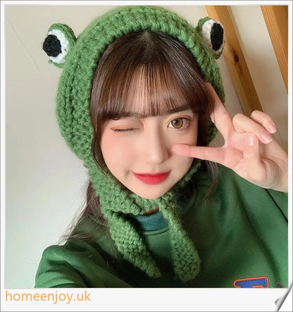 A cosy and stylish woollen hat featuring a charming cartoon frog design with big, expressive eyes