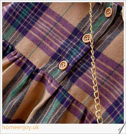 Baby girl wearing a long-sleeve dress with a grid pattern in purple and khaki colours