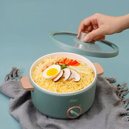 Multifunction Mini Electric Cooking Pot with Food Steamer - A compact and versatile kitchen appliance with non-stick surface and steamer attachment.