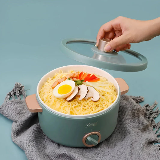Multifunction Mini Electric Cooking Pot with Food Steamer - A compact and versatile kitchen appliance with non-stick surface and steamer attachment.