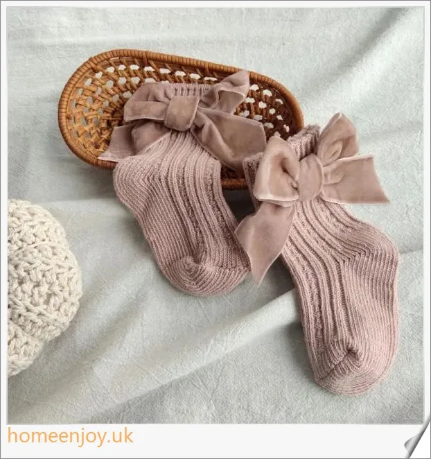 Soft, cosy baby socks with a charming bowknot design, available in a variety of classic colours