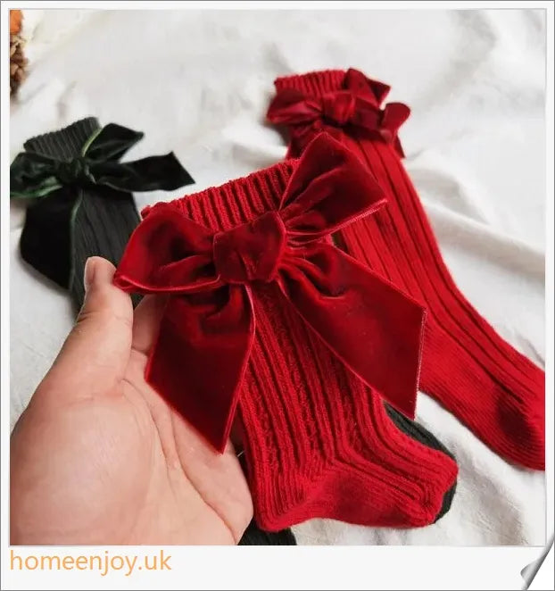 Soft, cosy baby socks with a charming bowknot design, available in a variety of classic colours