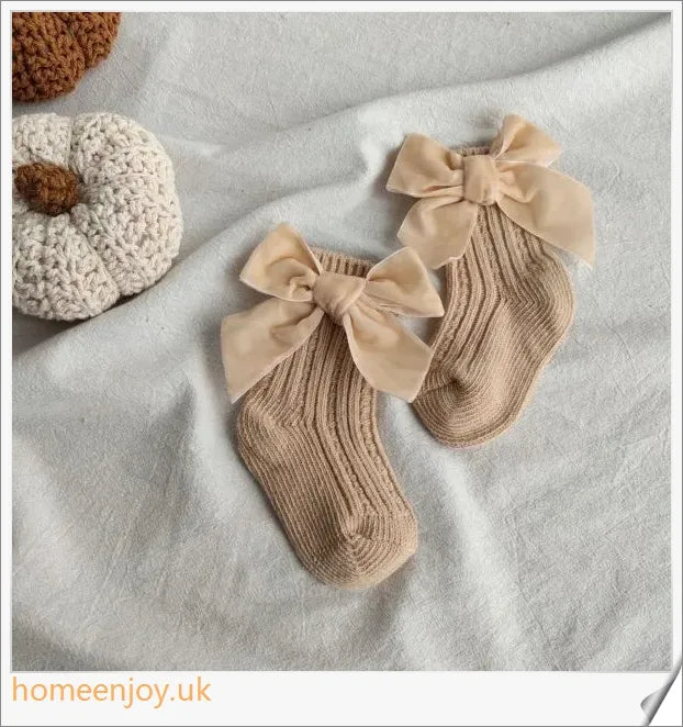 Soft, cosy baby socks with a charming bowknot design, available in a variety of classic colours