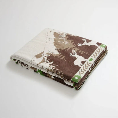 Cosy 100% cotton throw blanket with a scenic design of an elk in a mountain forest reflected in calm waters