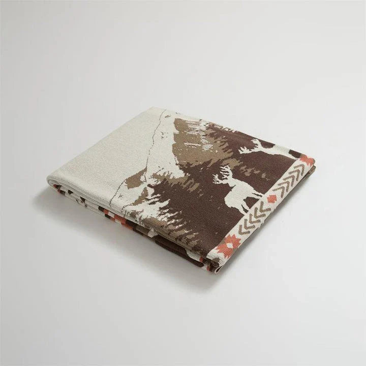 Cosy 100% cotton throw blanket with a scenic design of an elk in a mountain forest reflected in calm waters