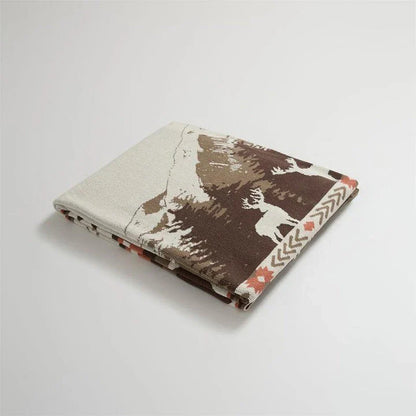Cosy 100% cotton throw blanket with a scenic design of an elk in a mountain forest reflected in calm waters