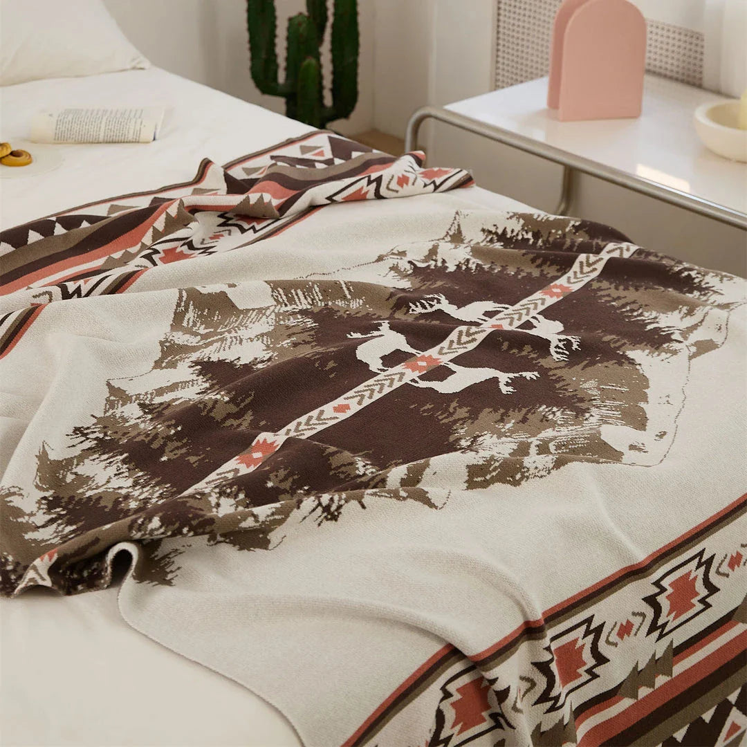 Cosy 100% cotton throw blanket with a scenic design of an elk in a mountain forest reflected in calm waters