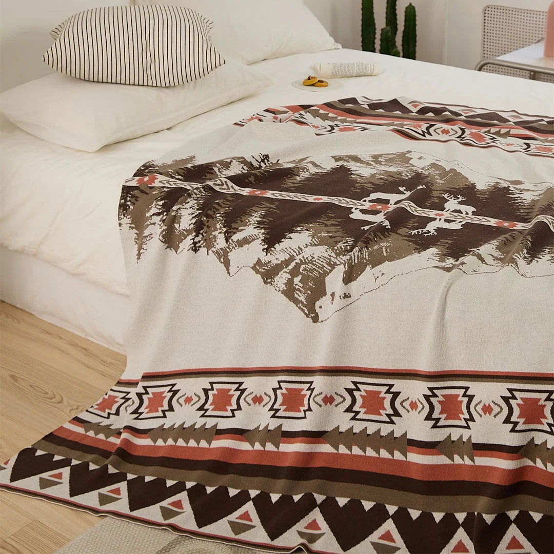 Cosy 100% cotton throw blanket with a scenic design of an elk in a mountain forest reflected in calm waters