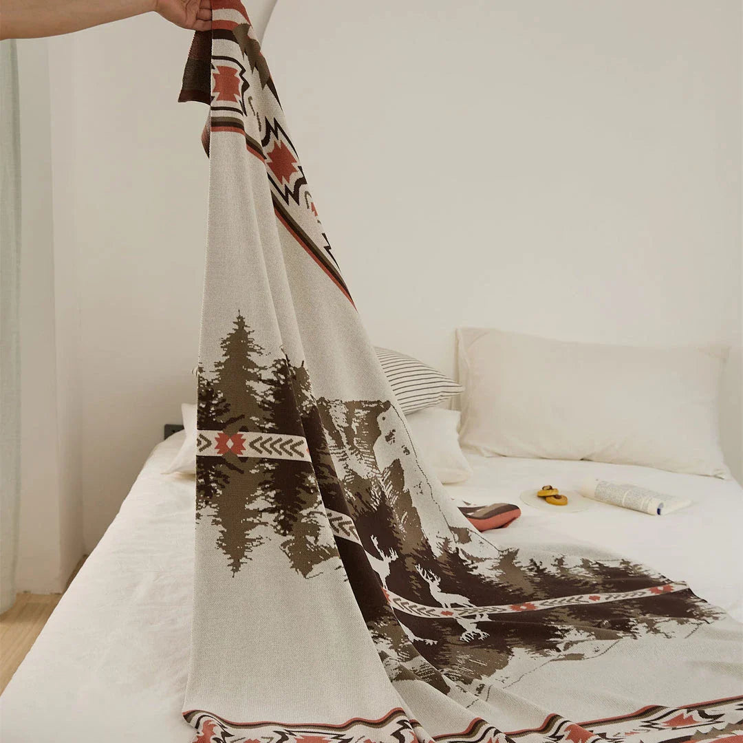 Cosy 100% cotton throw blanket with a scenic design of an elk in a mountain forest reflected in calm waters