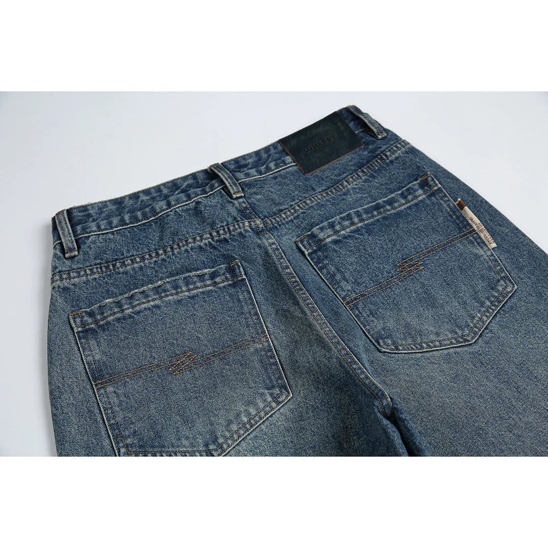 Autumn New Retro Loose Jeans in dark blue, featuring a tapered leg design and unique printing techniques for a vintage-inspired look.
