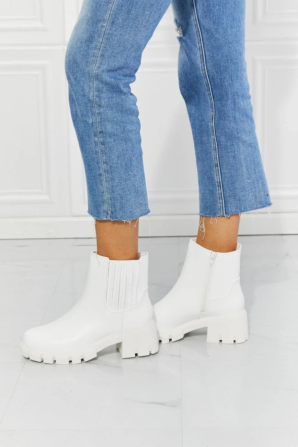 Faux patent leather lug sole Chelsea boots with a 2.5-inch block heel and a stretchy panel for easy on and off.