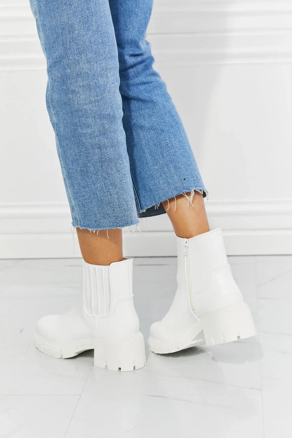 Faux patent leather lug sole Chelsea boots with a 2.5-inch block heel and a stretchy panel for easy on and off.
