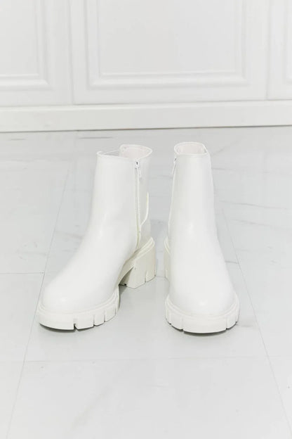 Faux patent leather lug sole Chelsea boots with a 2.5-inch block heel and a stretchy panel for easy on and off.
