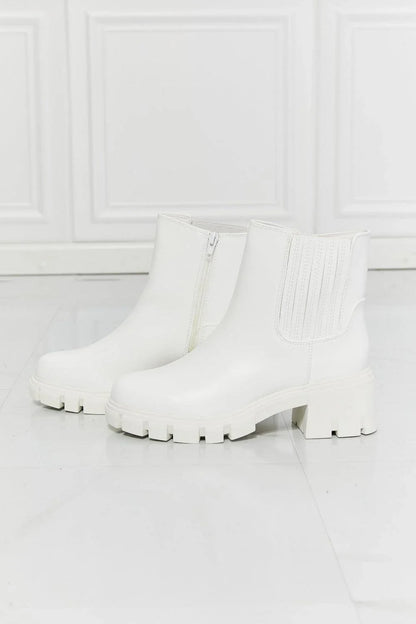 Faux patent leather lug sole Chelsea boots with a 2.5-inch block heel and a stretchy panel for easy on and off.