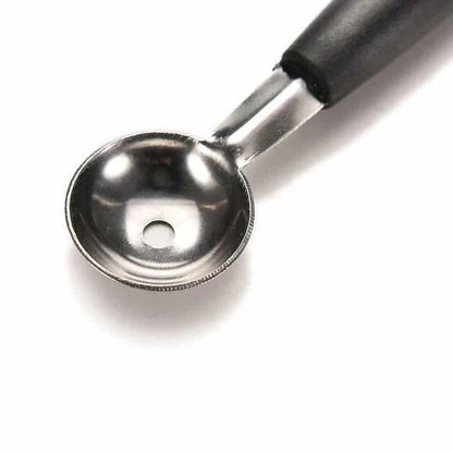 A premium double-ended stainless steel fruit carving scoop for creating intricate, Instagram-worthy culinary displays