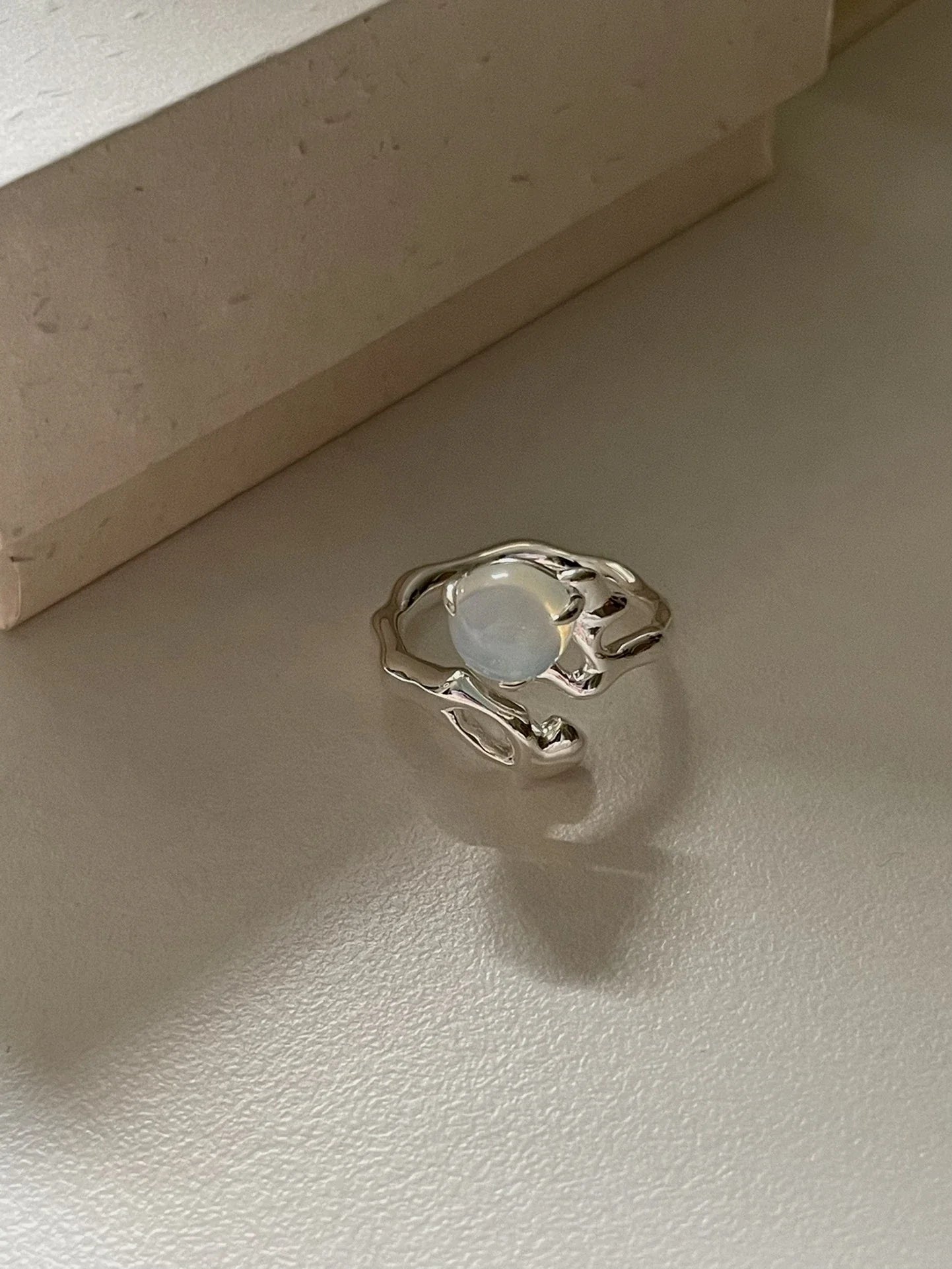 Adjustable sterling silver ring with natural zirconia stones, a versatile and elegant accessory.