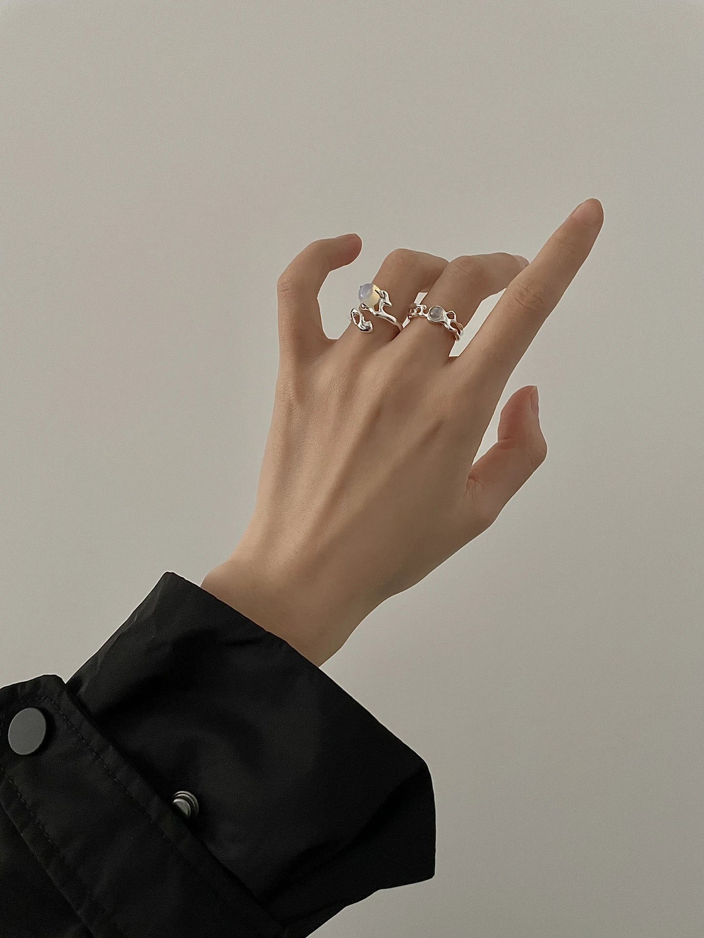 Adjustable sterling silver ring with natural zirconia stones, a versatile and elegant accessory.