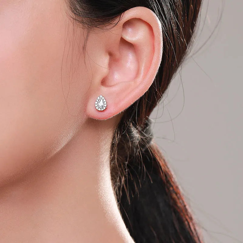 Women's drop-shaped ear studs crafted from 925 sterling silver with a diamond-cut treatment for a light-catching personality, suitable for female wearers seeking a simple jewellery piece.