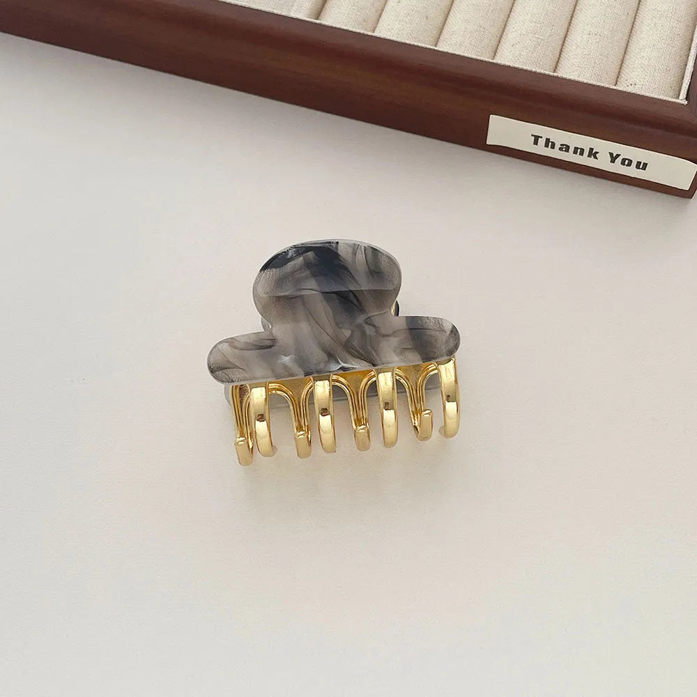 Acetate hair barrettes with metal alloy grip in leopard print, white, and ink colour options