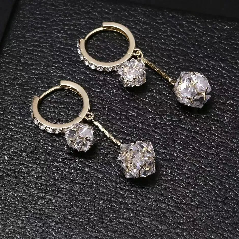 Silver drop earrings with tassel and rhinestone details on copper ear clips