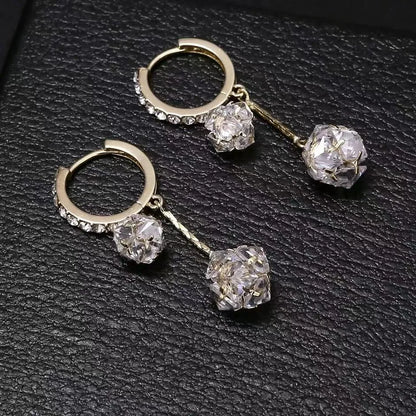 Silver drop earrings with tassel and rhinestone details on copper ear clips