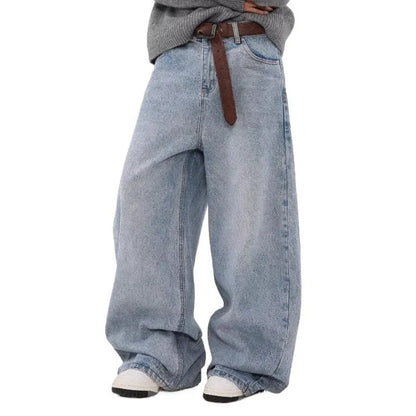 Man wearing retro blue washed straight leg distressed jeans with a mid-rise waist.