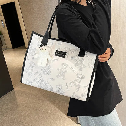 Women's black and white soft canvas tote bag with large capacity and printed rhombus pattern on front.