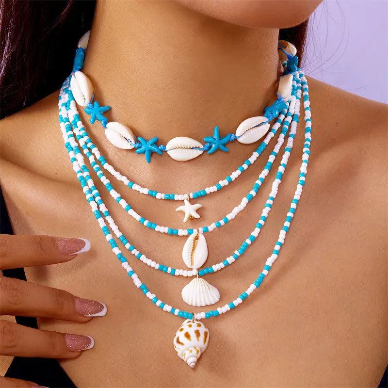 Five women's necklaces with starfish shell beads on adjustable chains in summer colours