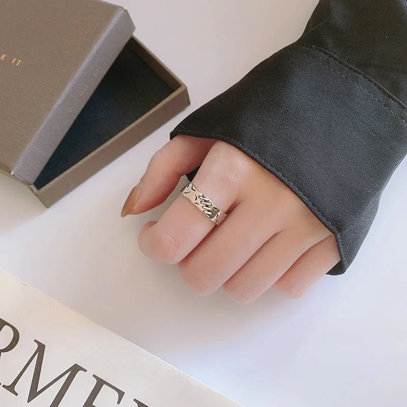 Women's fashion geometric ring with adjustable opening for universal fit, crafted from copper with black finish and round/oval elements suitable for student jewellery, influencer style, and promotional gift occasions.