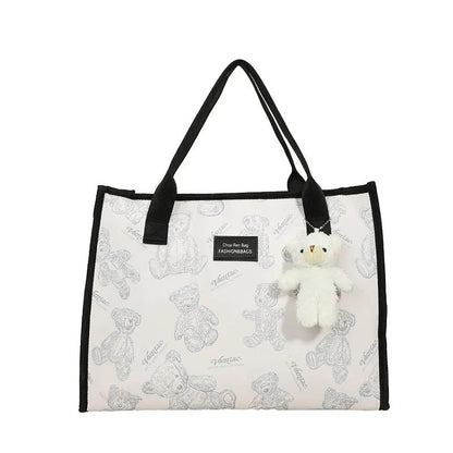 Women's black and white soft canvas tote bag with large capacity and printed rhombus pattern on front.