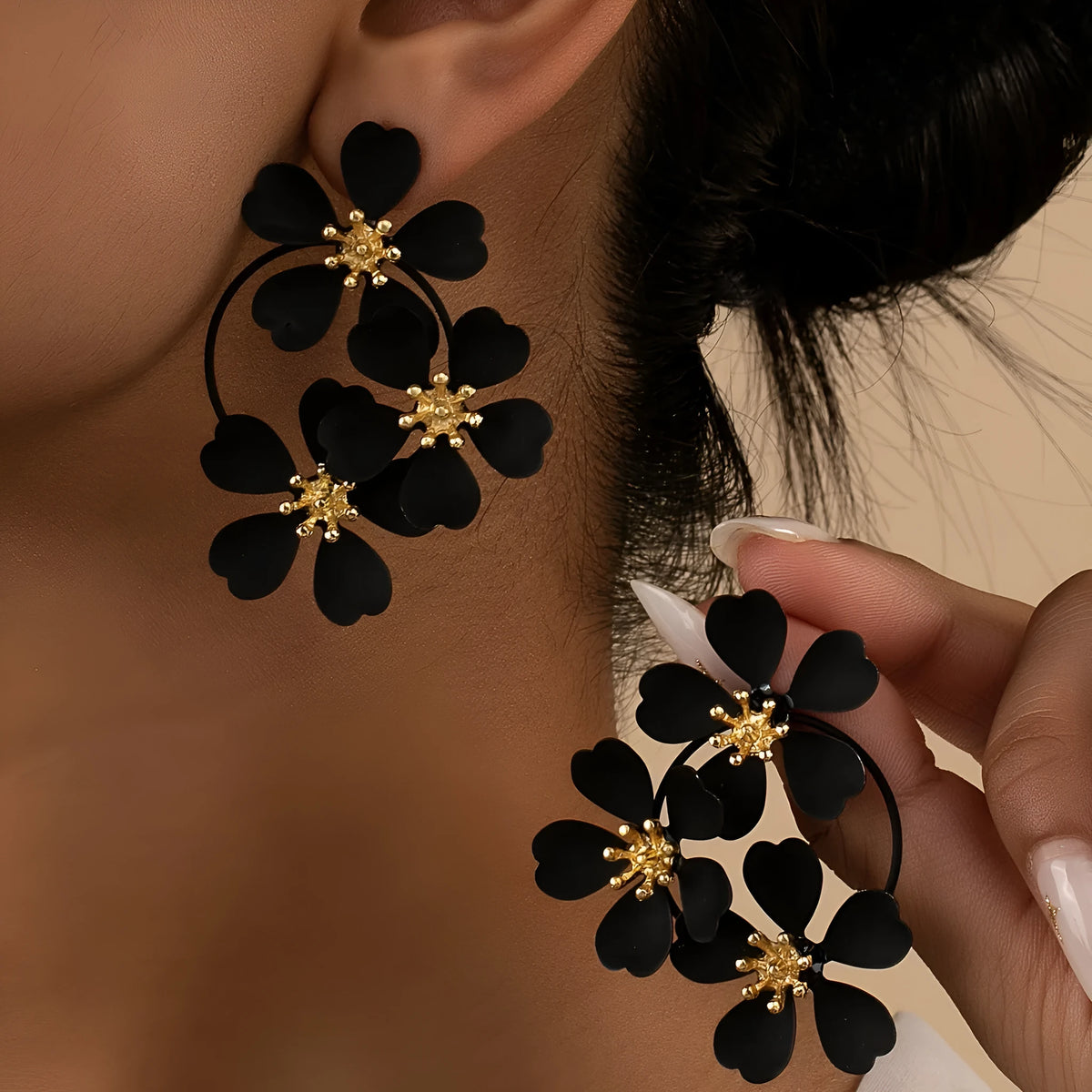 A pair of retro-style flower-shaped earrings for women, shown in black and white colour options.