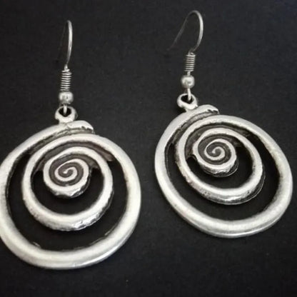 Retro geometric spiral earrings with a distressed silver finish.