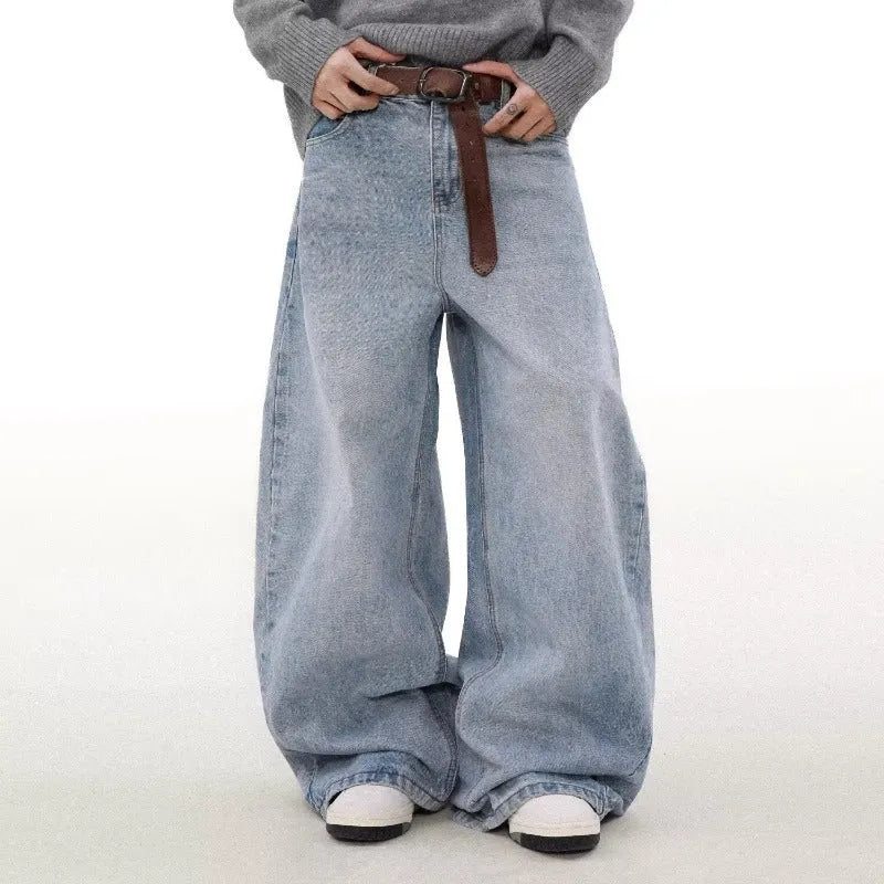 Man wearing retro blue washed straight leg distressed jeans with a mid-rise waist.