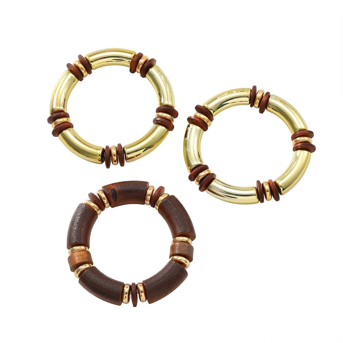 Layered bohemian jewellery set with a large round wooden pendant necklace and matching bracelet on a table.