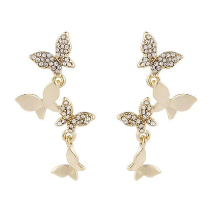 Women's gold copper butterfly drop earrings showing four-element dangle design
