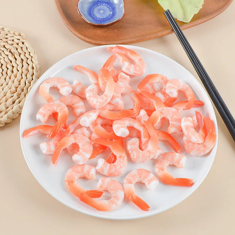 White PVC shrimp-shaped keychain with door buckle on a blue background.