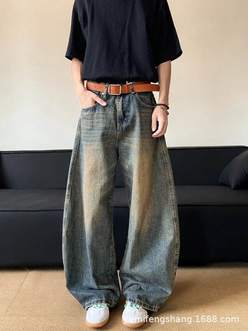 Men's distressed retro blue jeans with a slim wide-leg cut and mid waist.