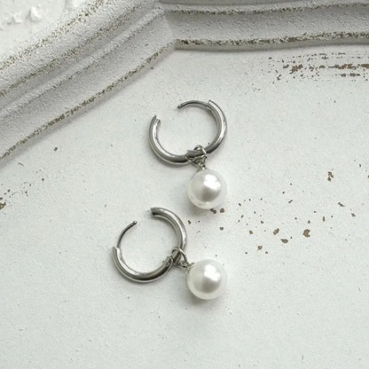 Women's geometric pearl drop earrings with titanium steel posts and round design elements