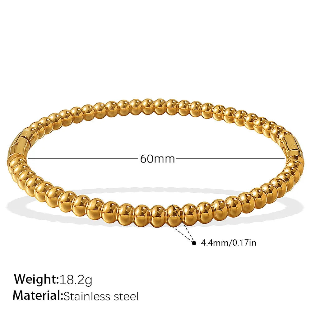 Stainless steel open-end bracelet with a buckle clasp in a choice of gold, silver, or zirconium gold electroplated finishes.