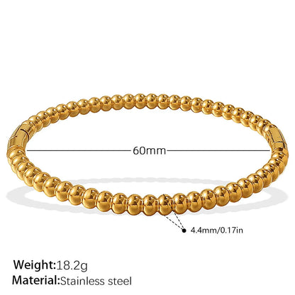 Stainless steel open-end bracelet with a buckle clasp in a choice of gold, silver, or zirconium gold electroplated finishes.