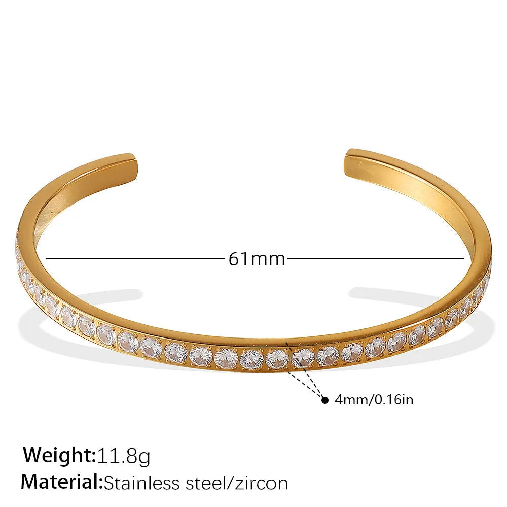 Stainless steel open-end bracelet with a buckle clasp in a choice of gold, silver, or zirconium gold electroplated finishes.