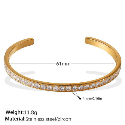 Stainless steel open-end bracelet with a buckle clasp in a choice of gold, silver, or zirconium gold electroplated finishes.