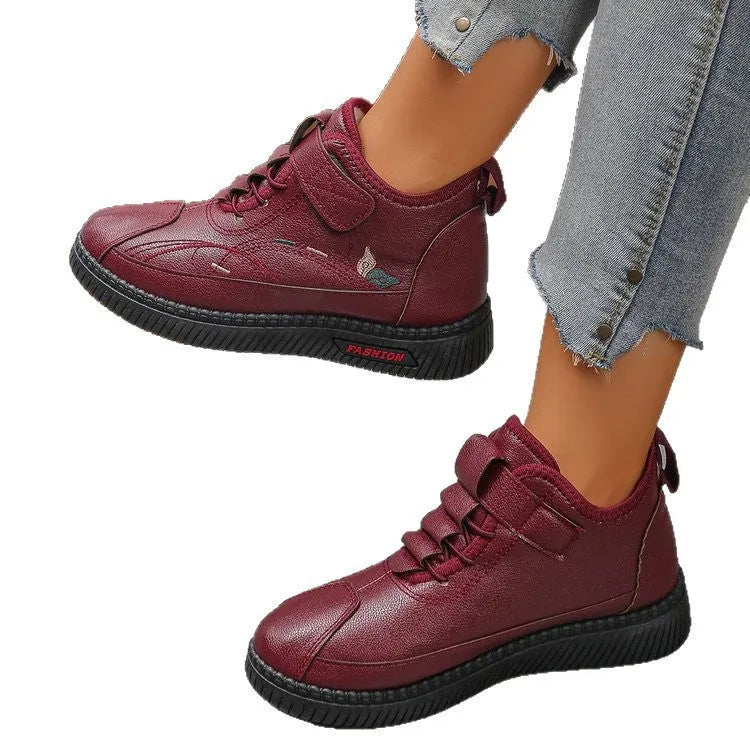 Women's black velvet indoor shoes with a non-slip rubber sole and low tube sock design.