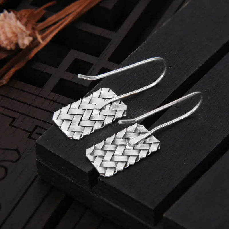 Pair of 925 silver geometric stud earrings with a woven diamond plaid texture on a white background.