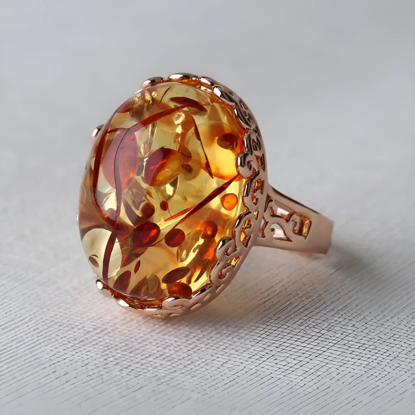 Close-up of a beeswax amber-coloured alloy ring with ethnic retro design on a hand.